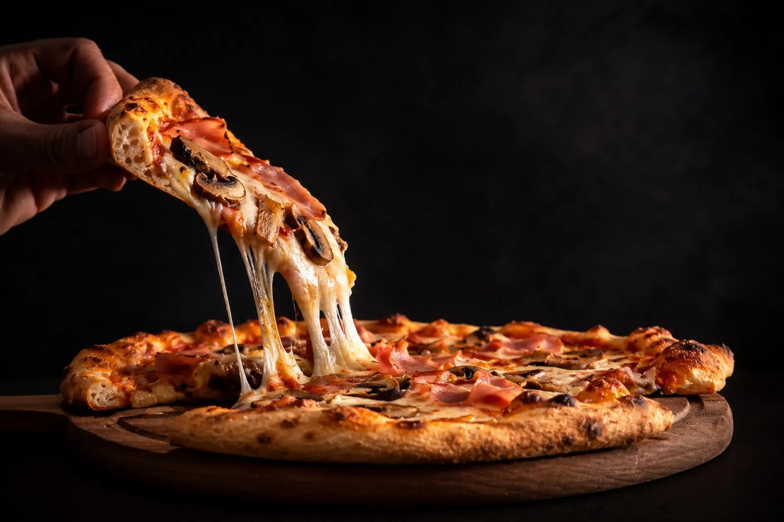 A hot cheese pizza being served to a hungry youth sports team at a group dinner in Alpharetta