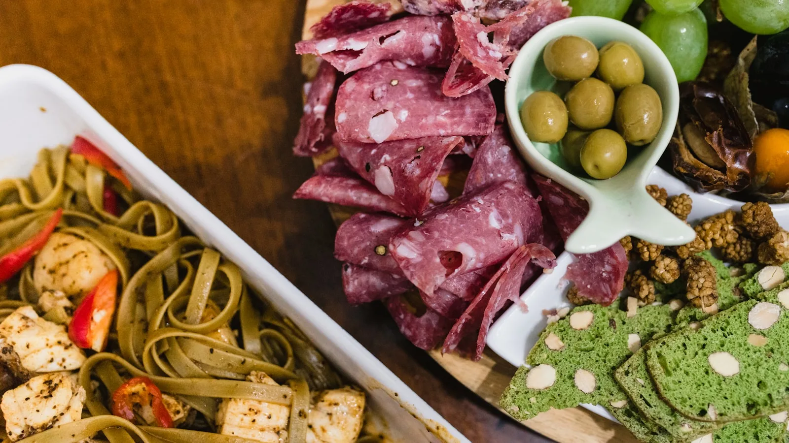An office catering spread with Italian trays, salad and pizza laid out on a conference table